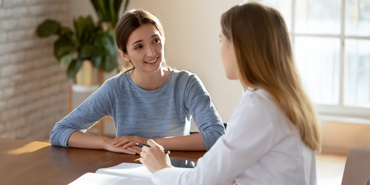 Young, caucasian woman consulting with a fertility specialist.