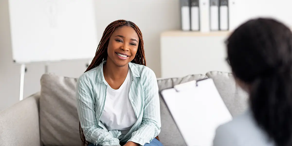 Young woman smiling at a consultation.