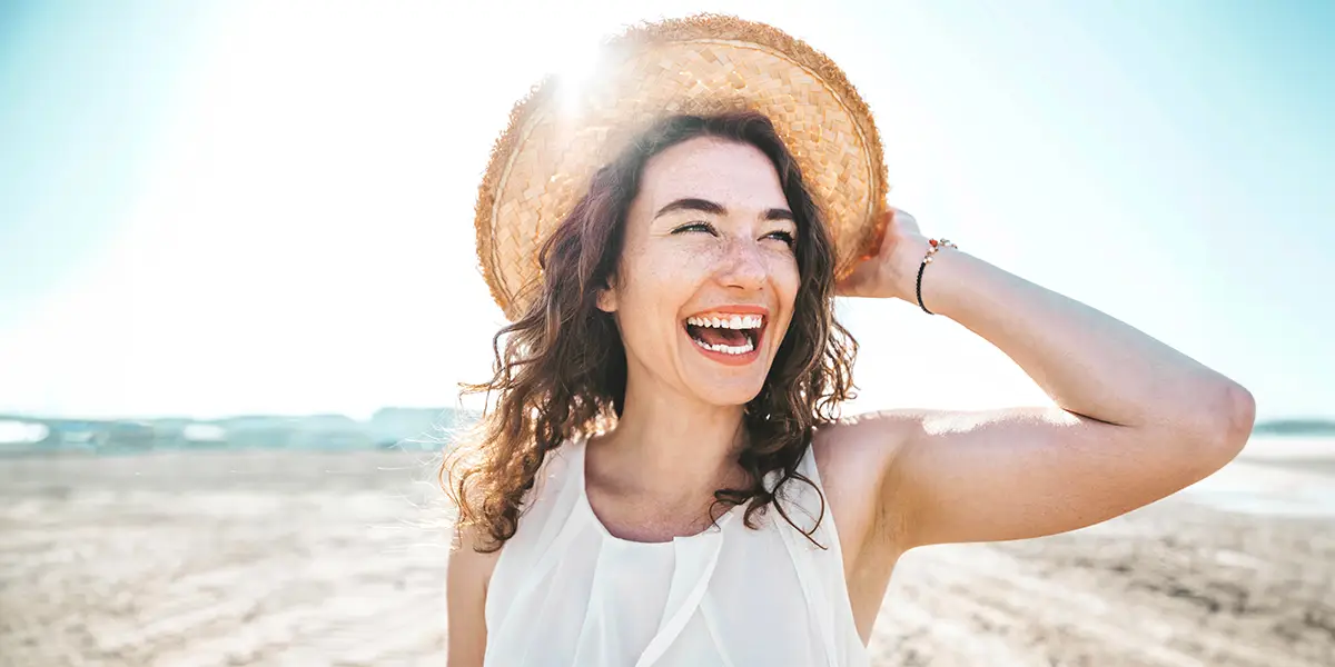 Smiling young woman on the beach.