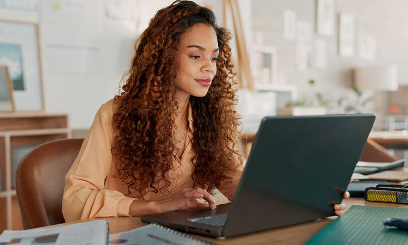 Beautiful mixed race woman using a laptop.