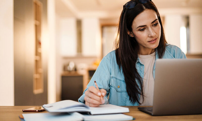 Young woman filling out an egg donor profile on a computer. 