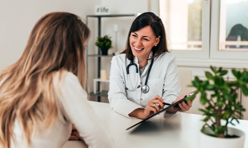 Young female patient talking to a female doctor.